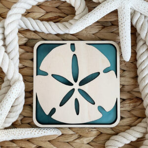 Sand Dollar Decor Coaster displayed in a wicker basket with rope and starfish.