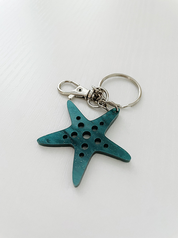 Starfish Keychain displayed on a white tabletop.